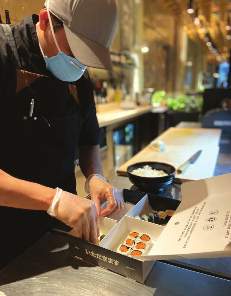Preparing an order with all of the necessary safety gear at Ryú.