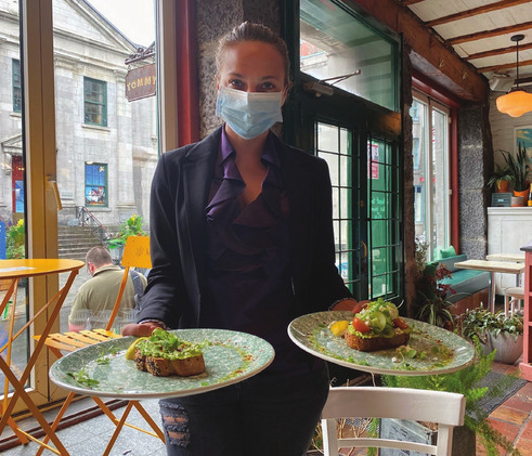 Tommy Café and Apéro Manager Giselle Serpa brings two delicious dishes to the table
