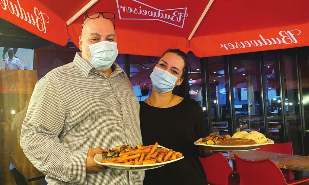Manager Costa Soilis and server Sophie deliver meals at Station des Sports