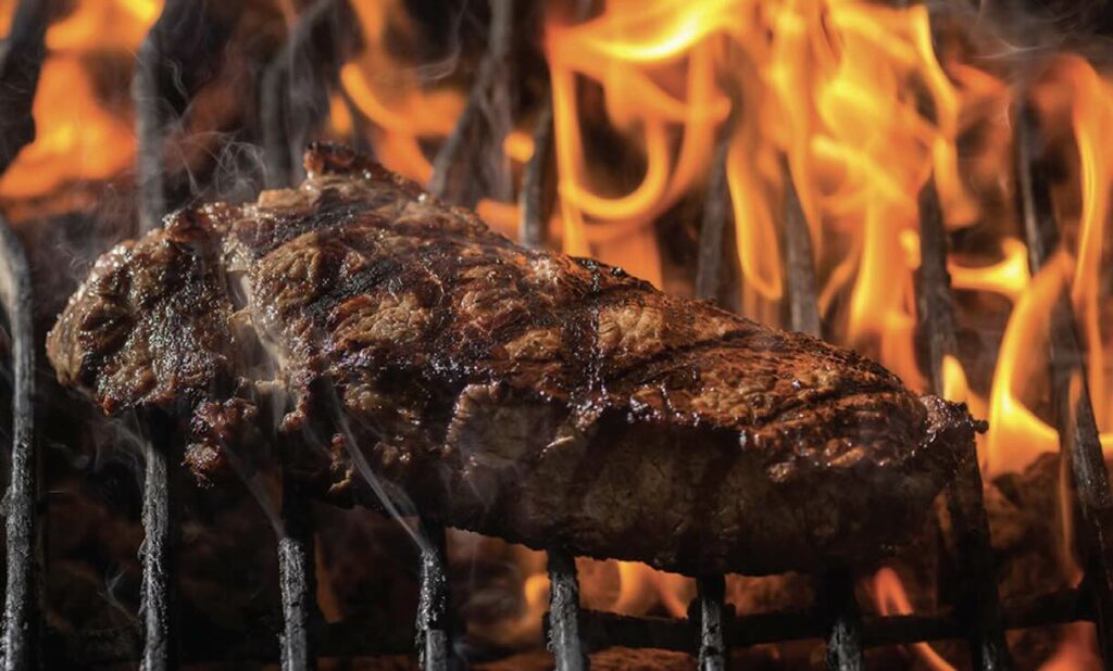 A sizzling steak on the grill at Al’s Steakhouse in Ottawa