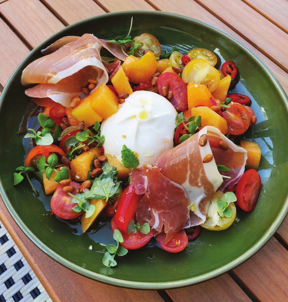 Burrata in a round green bowl