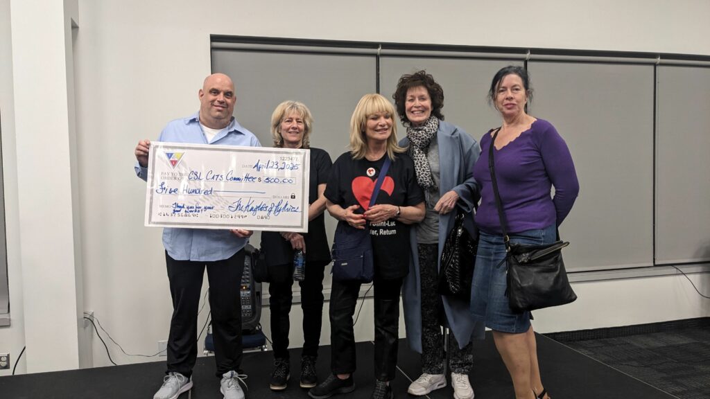 Brian Blumer presents the cheque to the CSL Cats Committee